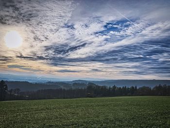 Scenic view of field against sky during sunset