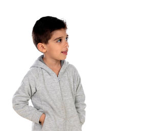 Boy looking away while standing against white background