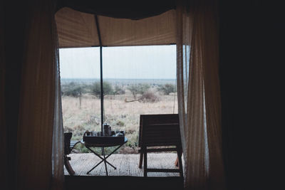 Chairs and table seen through window