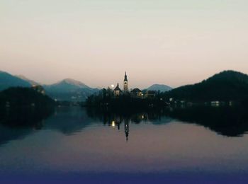 Reflection of house in calm lake