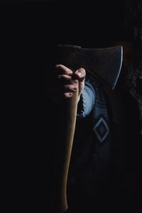 Close-up of man hand against black background