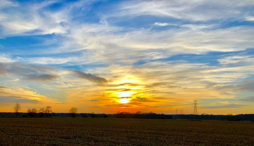 Scenic view of field against sky during sunset