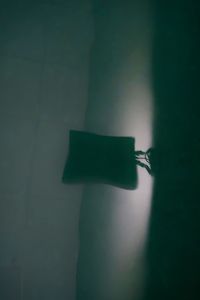 Close-up of paper on table against wall at home