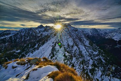 Scenic view of snowcapped mountains against sky during sunset