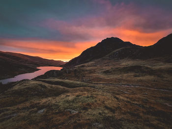 Scenic view of tryfan against sky during sunset