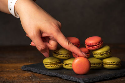 Midsection of person holding fruits on table