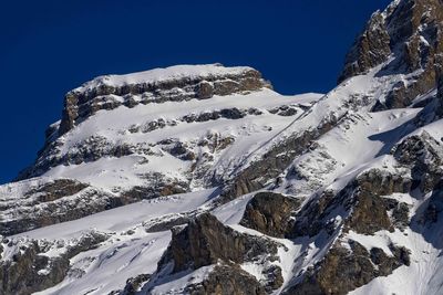 Scenic view of snowcapped mountains against clear sky