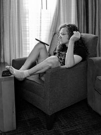 Young man sitting on sofa at home and relaxing 