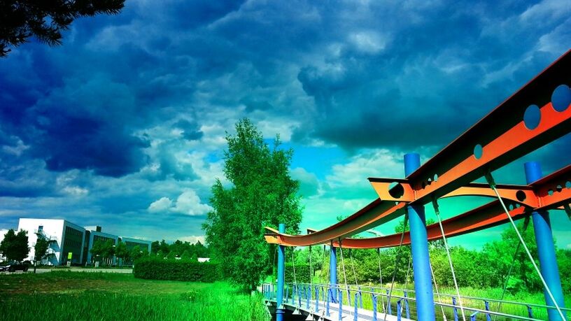 sky, cloud - sky, cloudy, cloud, grass, tree, railing, built structure, nature, architecture, tranquility, weather, field, overcast, bench, empty, outdoors, dramatic sky, tranquil scene, storm cloud