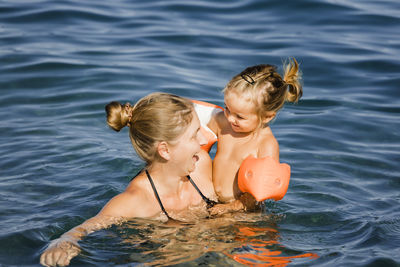 Close-up of mother and daughter in sea
