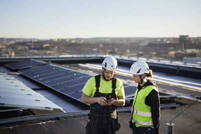 Workers standing on roof