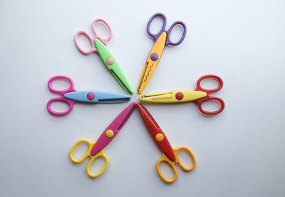 High angle view of multi colored pencils on white background