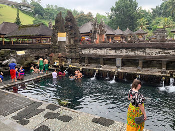 People at temple against buildings