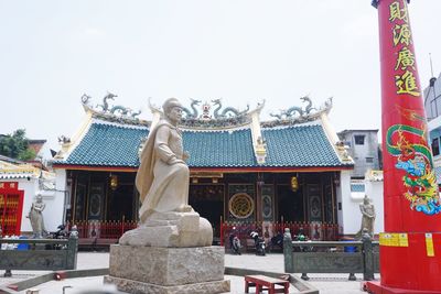 Statue of temple against building