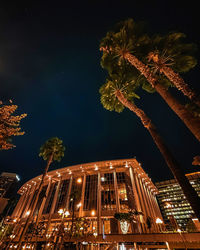 Low angle view of illuminated building against sky at night