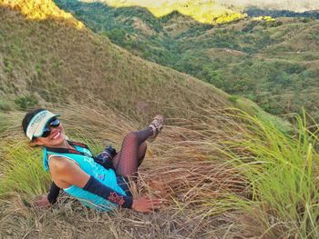 Woman sitting on grassy field