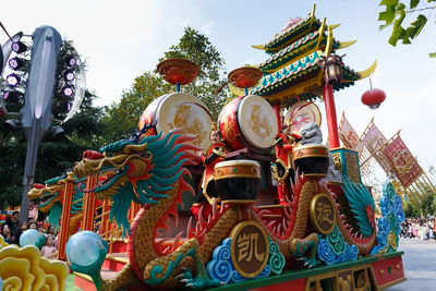 Low angle view of statues on building against sky