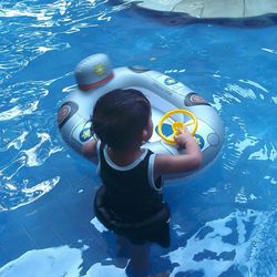 High angle view of boy swimming in pool