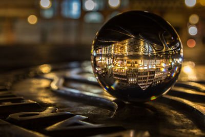 Close-up of illuminated lamp on table