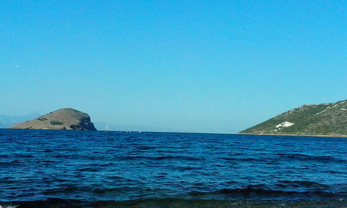 Scenic view of sea against clear blue sky