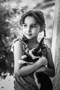 Portrait of smiling girl holding horse