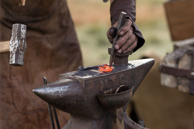 Midsection of man holding fire hydrant