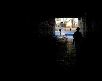 Silhouette man walking in city