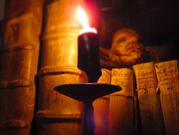 Close-up of lit candles in the dark