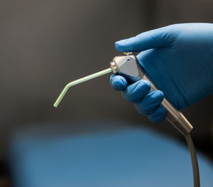 Close-up of dentist holding dental equipment