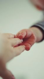 Cropped image of child holding mother