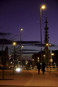 Illuminated city street at night