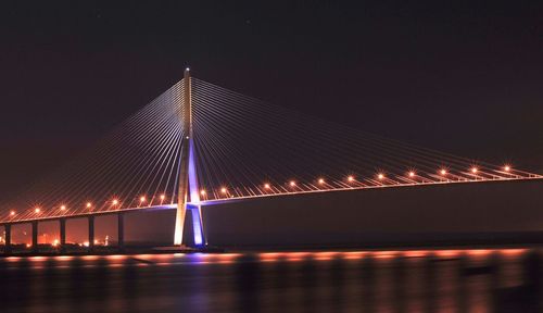 Low angle view of suspension bridge at night