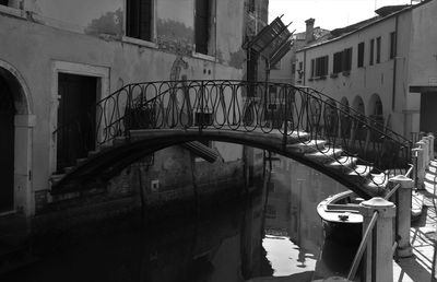 Bridge over canal amidst buildings in city