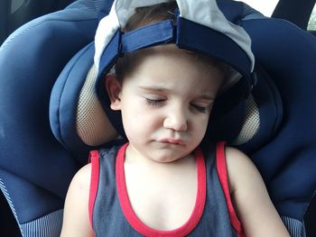 Close-up of boy sleeping in car