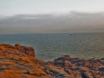 Scenic view of sea against cloudy sky