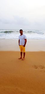 Full length of man standing on beach