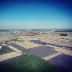 Aerial view of agricultural field against clear blue sky