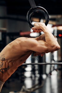 Cropped hand of man exercising in gym