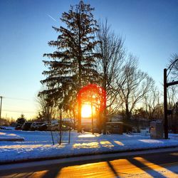 Snow covered landscape at sunset
