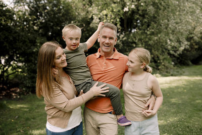 Portrait of happy family standing at park