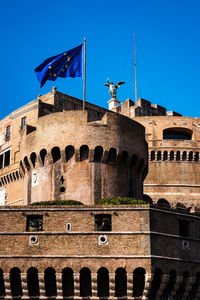 Low angle view of historical building against blue sky