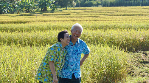 Asian senior elder couole hawaii shirts with agriculture rice farm