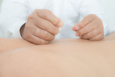 Close-up of person lying on hand