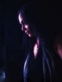 Portrait of beautiful woman in darkroom