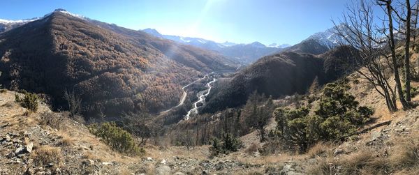 Scenic view of land and mountains against sky