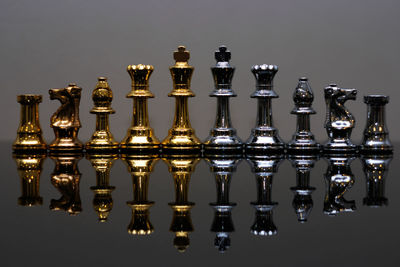 Close-up of chess pieces arranged on gray background