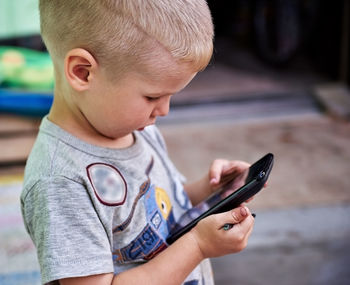 Boy using smart phone at home