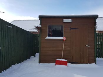 Lifeguard hut on snow against sky