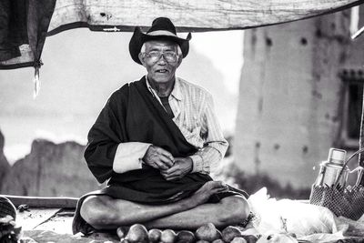 Portrait of senior vendor selling fruits