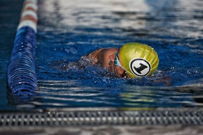 Portrait of young woman swimming in pool